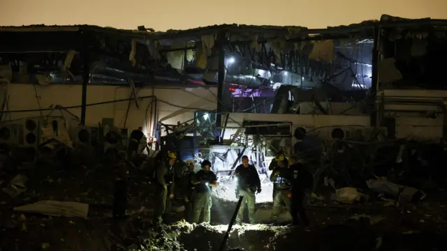 Emergency personnel work at the site of damage after a barrage of Iranian missiles was launched at Israel, amid the U.S.-Israel conflict with Iran, in Petah Tikva, Israel, April 2, 2026.