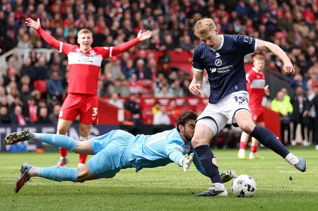 Sol Brynn of Middlesbrough makes a save against Josh Coburn of Millwall
