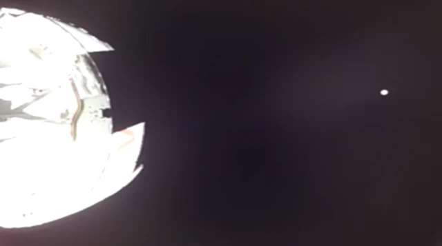 This shot of the small dot on the far right side of the screen shows Earth fading into the distance as the spacecraft is propelled into space towards the Moon