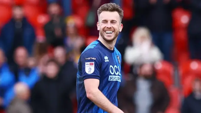 A smiling Mansfield goalscorer Rhys Oates