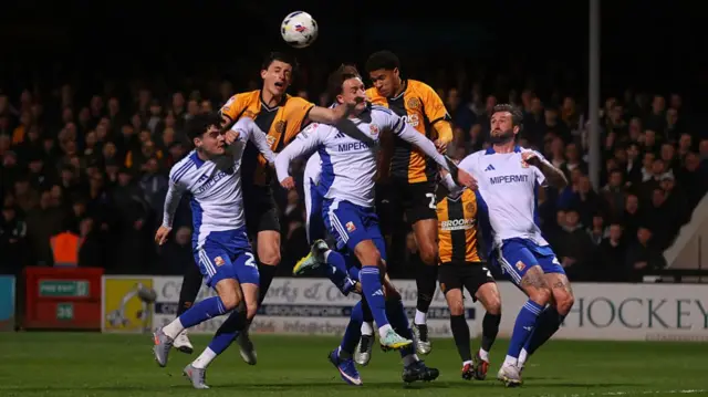 Kelland Watts of Cambridge United heads the ball during the League Two match between Cambridge United and Swindon Town a