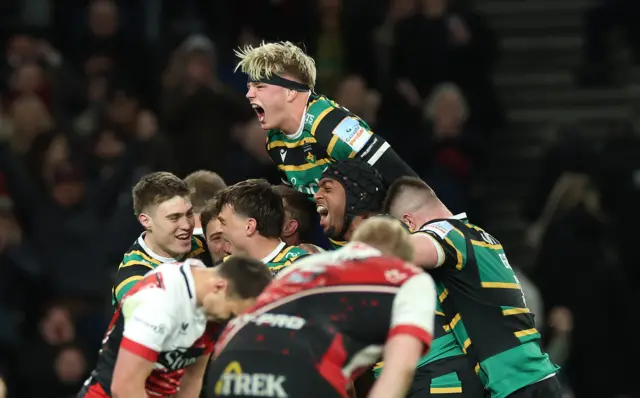 Henry Pollock celebrates with Northampton players