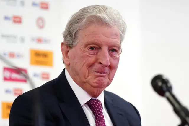 Roy Hodgson sits in front of a microphone
