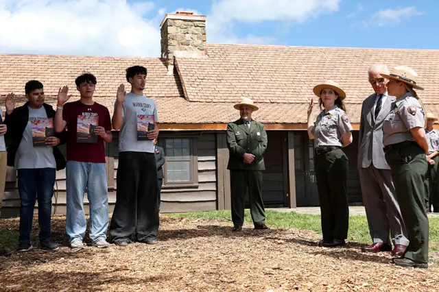 King Charles watches a group of junior park rangers being sworn in