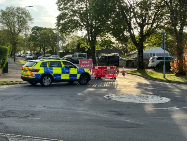 A police car in front of a road closed sign in Southway.
