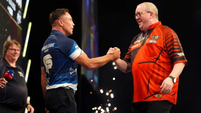 Gerwyn Price (left) shakes hands with Stephen Bunting after victory in their match on night thirteen of the BetMGM Premier League 2026 at P&J Live, Aberdeen.
