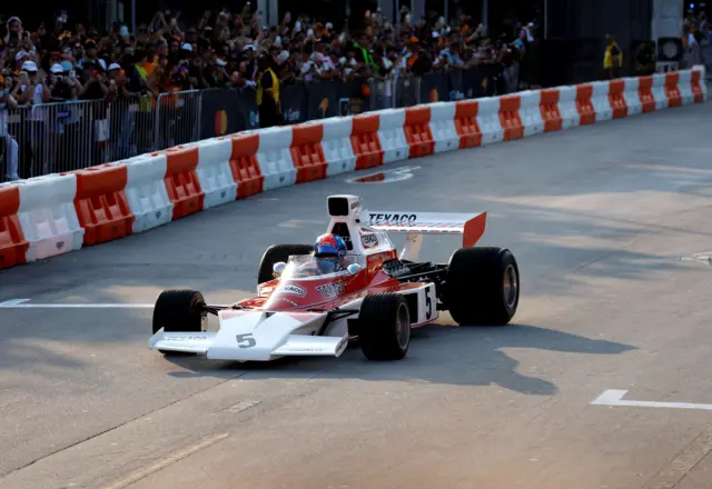 Emerson Fittipaldi drives the McLaren M23 in which he won the 1974 drivers' championship and James Hunt took the 1976 title