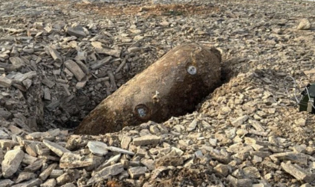 A WW2 bomb in gravel.