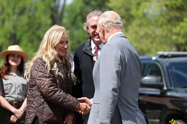 King shakes hands with the wife of US Secretary of the Interior Doug Burgum