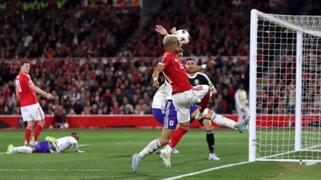 Omari Hutchinson of Nottingham Forest has a shot which is handled by Lucas Digne of Aston Villa leading to a penalty