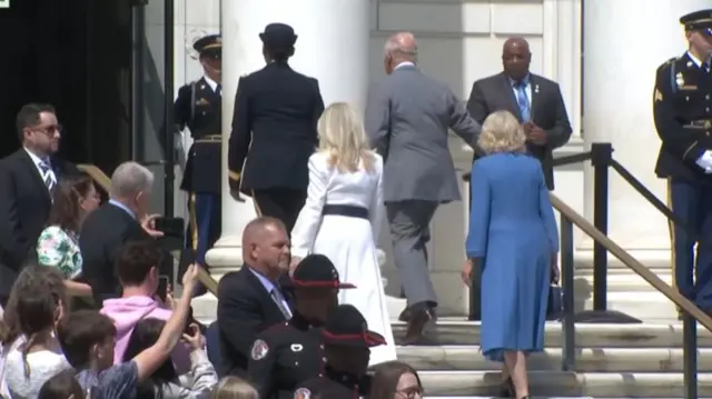 King and Queen enter a building up some stairs