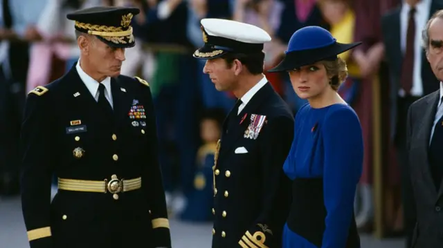 Prince Charles, wearing a military uniform, standing beside Princess Diana