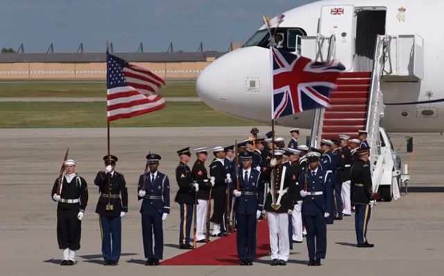 Military personnel await the arrival of the King and Queen for their departure from Joint Base Andrews