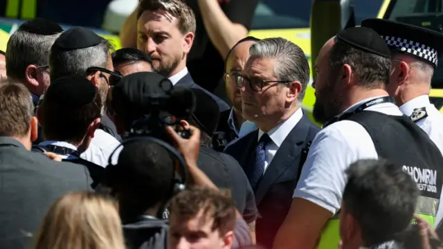British Prime Minister Keir Starmer makes a visit to the Golders Green area, surrounded by police and crowd of people.