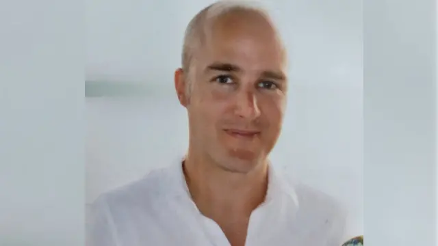 A picture of Alexander Cashford smiling at the camera