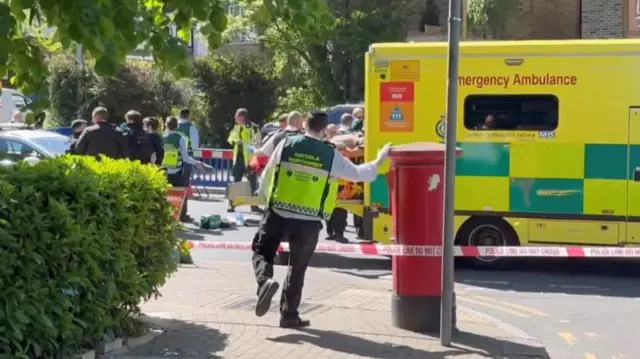 A Hatzola volunteer at a crime scene, with an NHS ambulance also visible