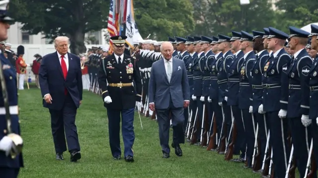 U.S. President Donald Trump and Britain's King Charles review the honour guard during the arrival ceremony for the king on the South Lawn of the White House, as the Washington Monument appears in the distance, in Washington, DC