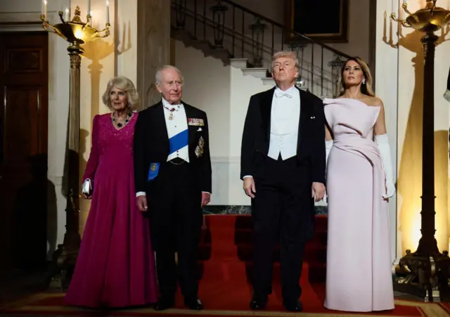 U.S. President Donald Trump, first lady Melania Trump, Britain's King Charles and Queen Camila pose in front of the Grand Staircase prior to a state dinner at the White House