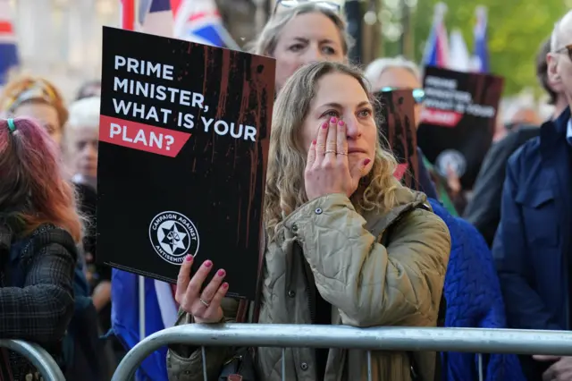 People attend a Campaign Against Antisemitism 'national emergency' rally in Whitehall, central London, following two people being stabbed in Golders Green, north-west London on Wednesday.