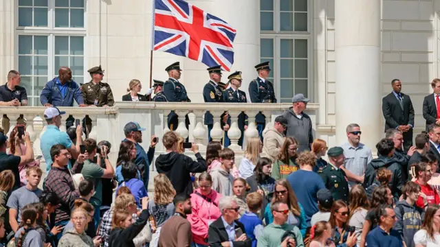 crowd of onlookers beside building