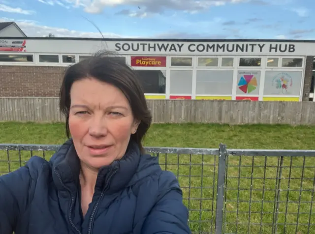 Angela standing outside of the community hub.