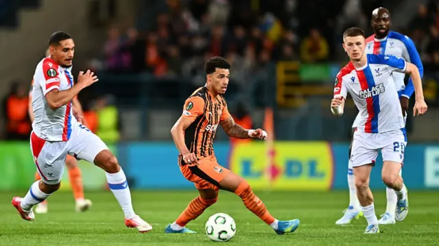 Kaua Elias of FC Shakhtar Donetsk on the ball while under pressure from Maxence Lacroix and Adam Wharton of Crystal Palace