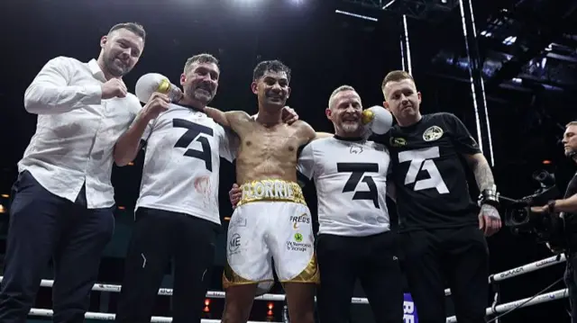 eo Alin celebrates victory with his coaching staff after defeating Kane Shepherd