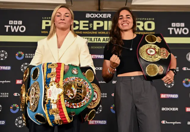 Lauren Price holds the WBC, WBA and IBF welterweight titles and stands next to Stephanie Pineiro who is holding the interim WBA title