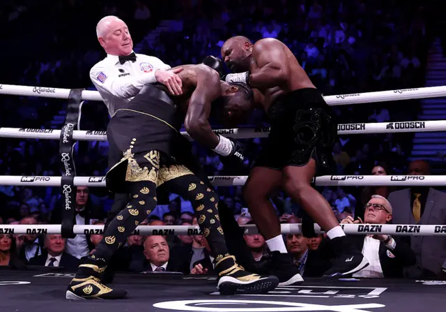 Referee pulls Deontay Wilder away from Derek Chisora