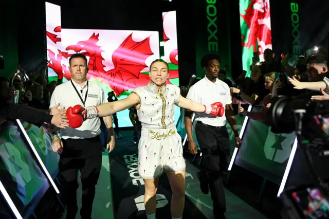 Lauren Price makes her ringwalk with her arms out to the crowd