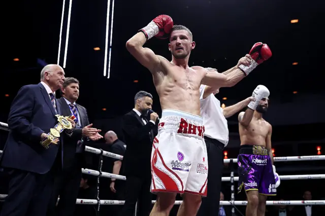 Rhys Edwards and Gully Powar have both their hands raised as fight is declared a draw