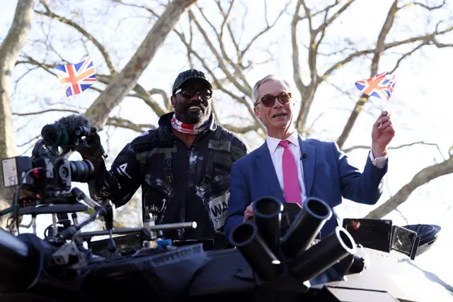Derek Chisora and Nigel Farage wave Union Jack flags