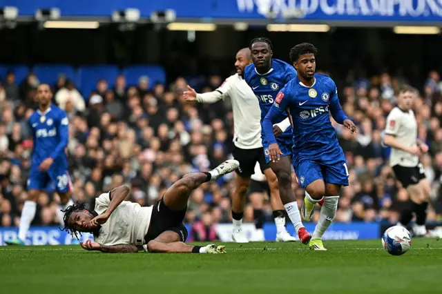 Rhys Walters fouled by Chelsea's Belgian midfielder Romeo Lavia