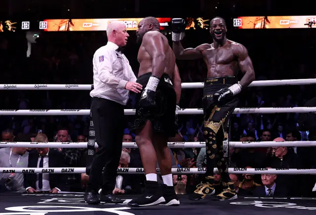 Deontay Wilder celebrates in the ring with Derek Chisora