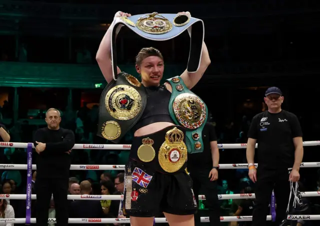 Lauren Price holding the WBC, IBF & WBA welterweight world titles