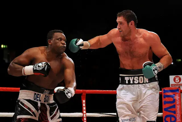 Tyson Fury throws a punch at Derek Chisora