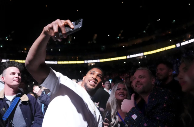 Anthony Joshua takes selfies with fans
