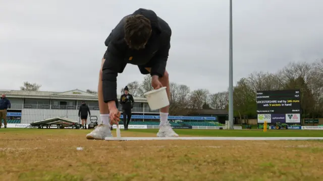 Groundstaff mark the crease at Leicester