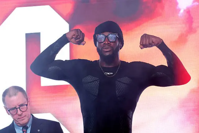Deontay Wilder holds up his arms