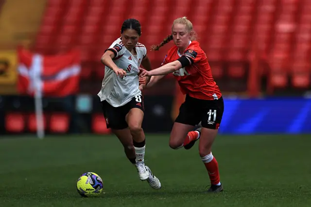 Fuka Nagano of Liverpool is challenged by Lucy Fitzgerald of Charlton Athletic