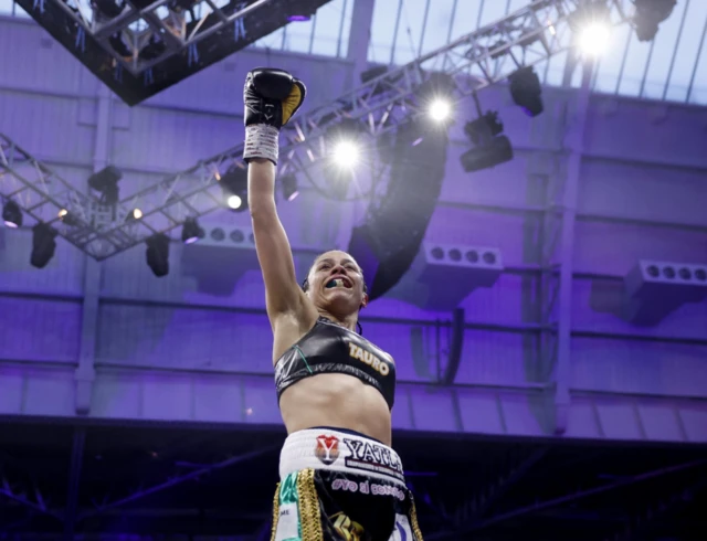Irma Garcia celebrates with her hand up