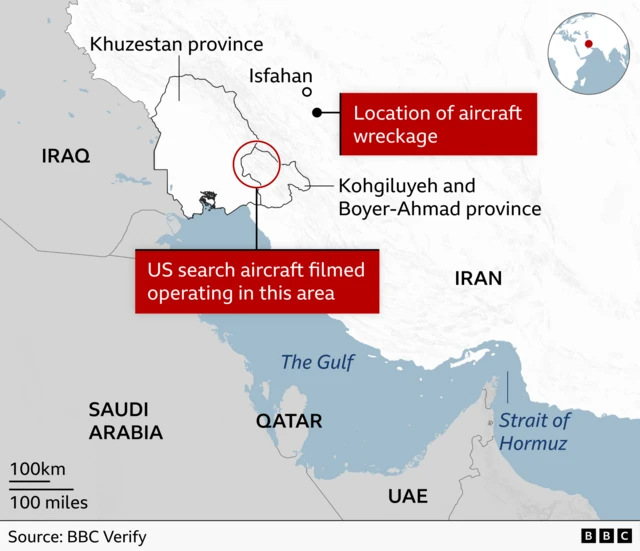 A map showing western and southern Iran, the Gulf, and neighbouring countries. A red label near the city of Isfahan marks the “Location of wreckage of US aircraft”. Another red label further south marks the area where “US search aircraft filmed operating” pointing to a location around the Kohgiluyeh and Boyer‑Ahmad province and Khuzestan province. Surrounding countries labelled include Iraq to the west, Saudi Arabia to the southwest, and Qatar, the UAE and Oman to the south of Iran.