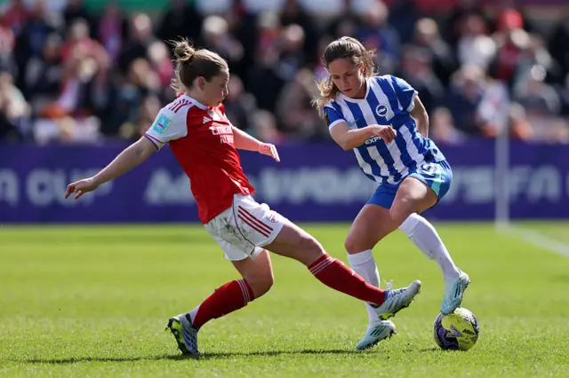 Kim Little of Arsenal battles for possession with Marisa Olislagers of Brighton & Hove Albion