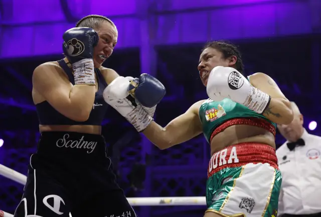 Ellie Scotney and Flores punch each other