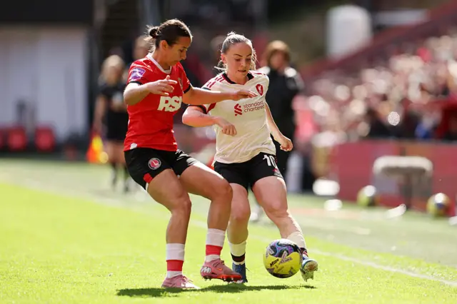 Lily Woodham of Liverpool is challenged by Gloria Siber of Charlton Athletic