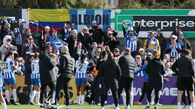 Brighton players celebrate with their fans