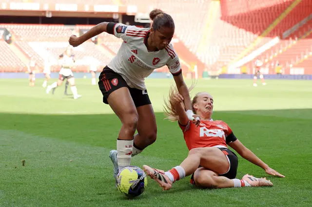 Aurelie Csillag of Liverpool is challenged by Charlotte Newsham of Charlton Athletic