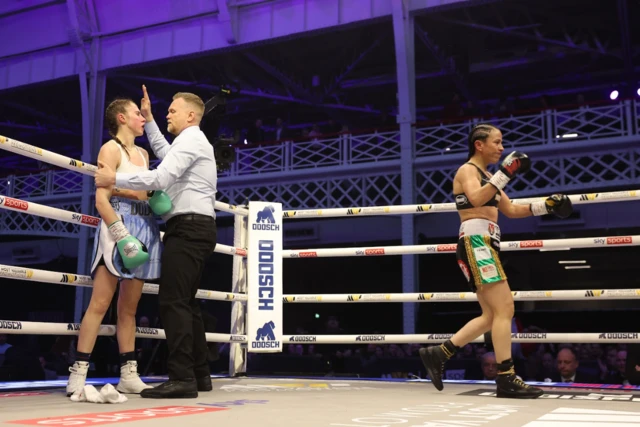 Emma Dolan is held by the referee as the towel is thrown in