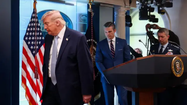 Donald Trump leaves White House briefing room