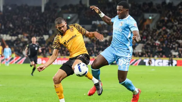 Hull's Cody Drameh and Coventry's Ephron Mason-Clark compete for the ball